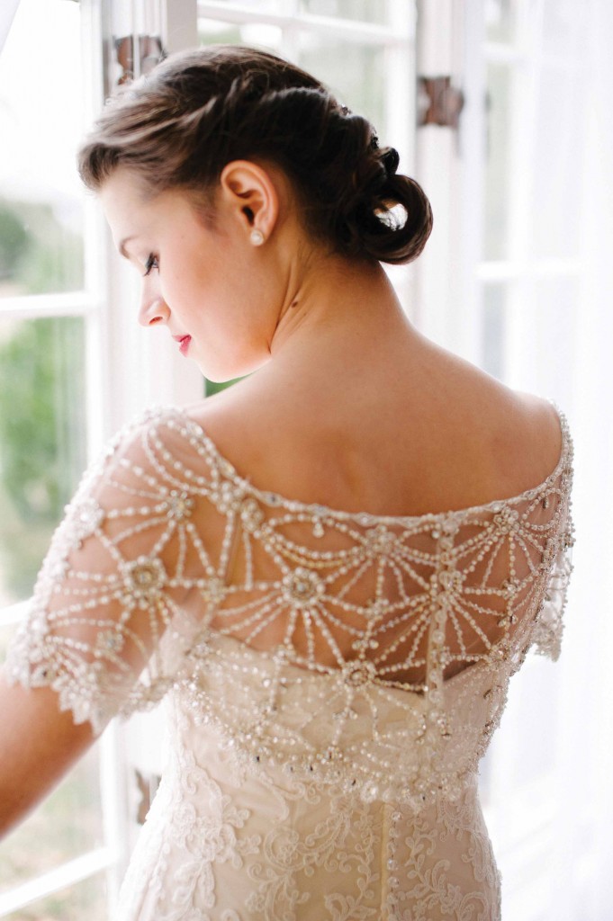Bride in her wedding dress by a window